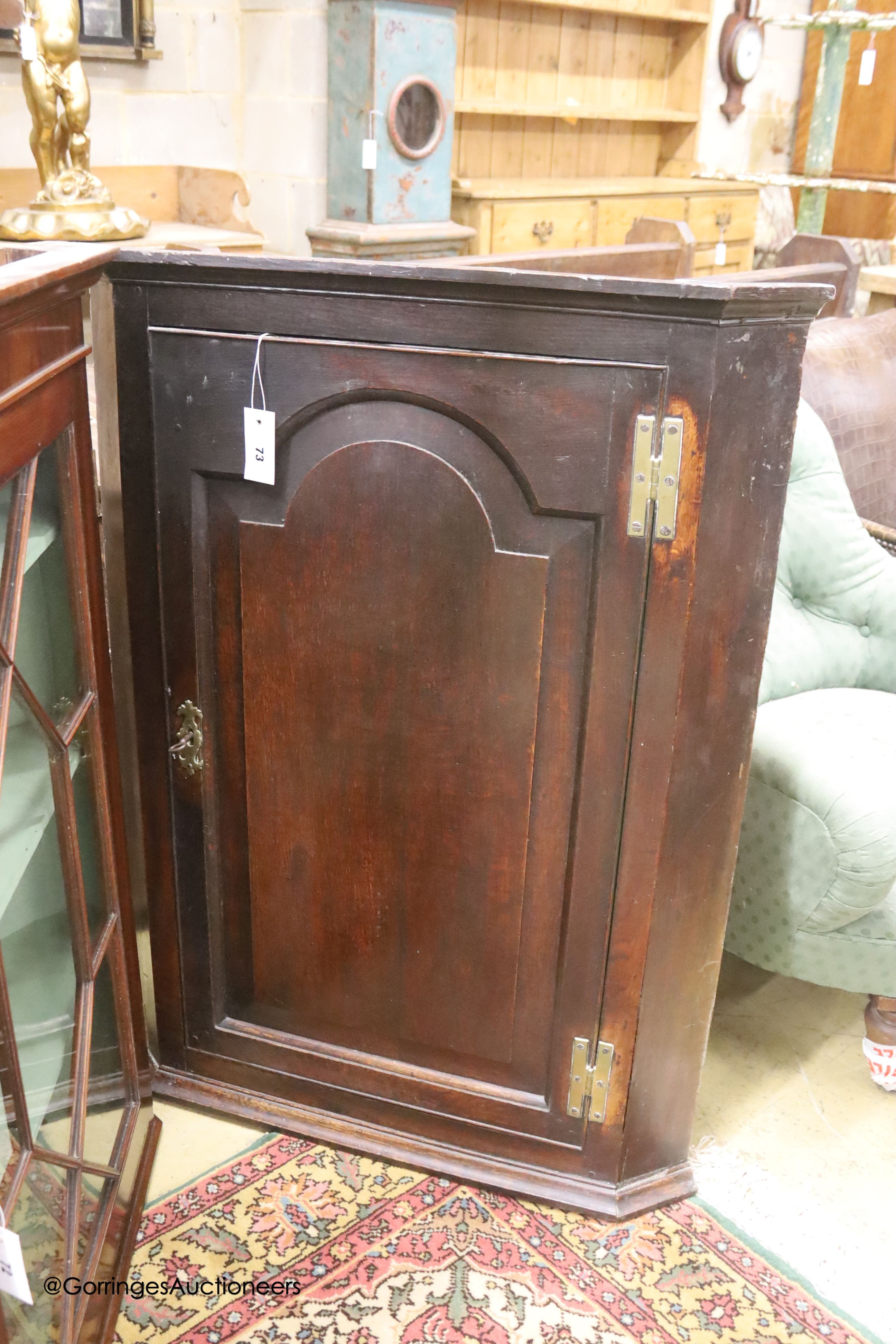 A George III oak wall-hanging corner cabinet, width 75cm, depth 42cm, height 101cm